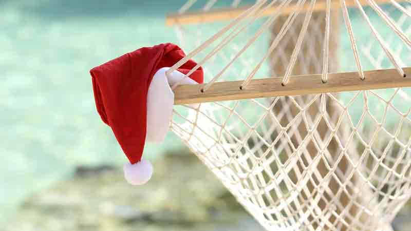 santa-hat-tropics Santa hat hanging off a hammock on a tropical beach