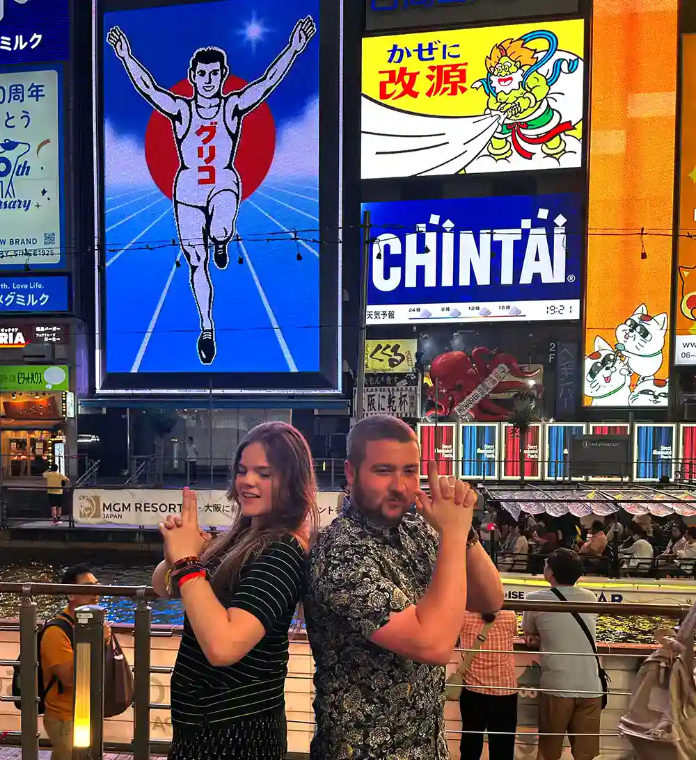 Friends have some fun posing in front of The Running Man on awarded Japan tour 