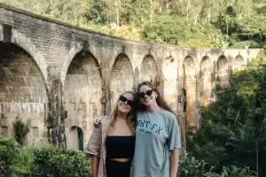 One Life Adventures female travel guests stand in front of the Nine Arch Bridge, Sri Lanka