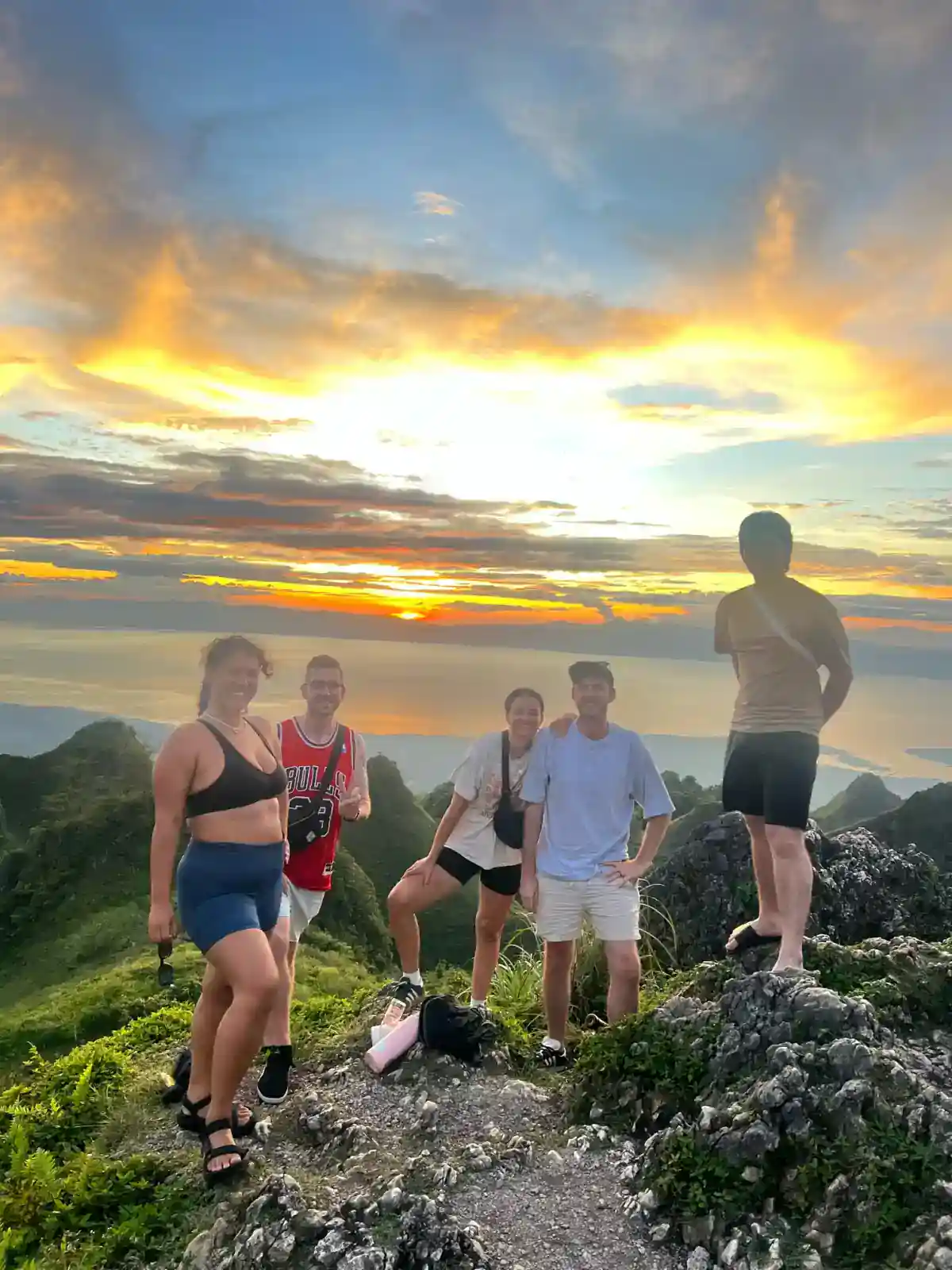 Small group of travellers at sunset on Osmeña Peak, the highest point on Cebu, on a 3 week Philippines itinerary
